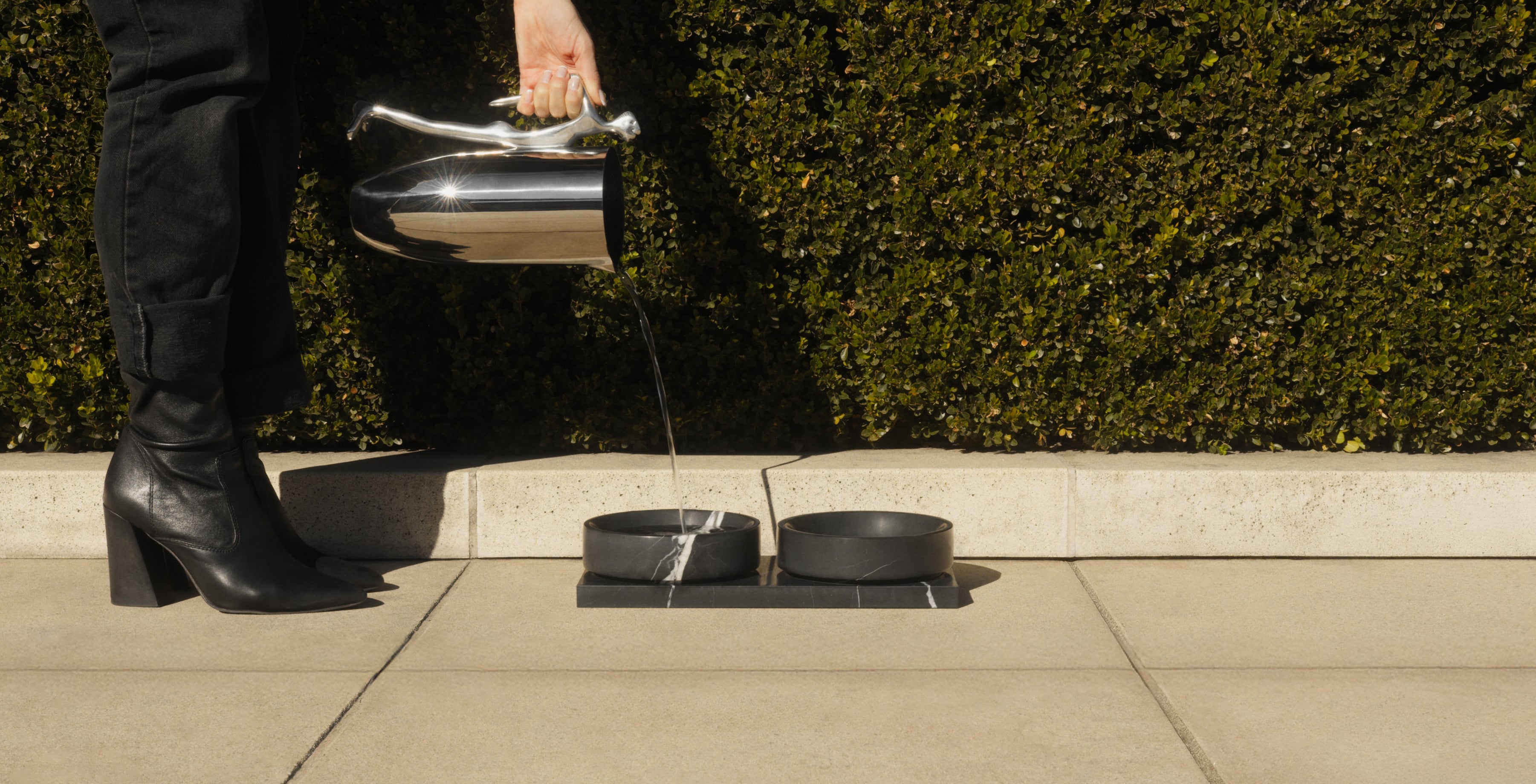 Mila Nero elevated pet bowls made from Nero Marquina marble outdoors - centered