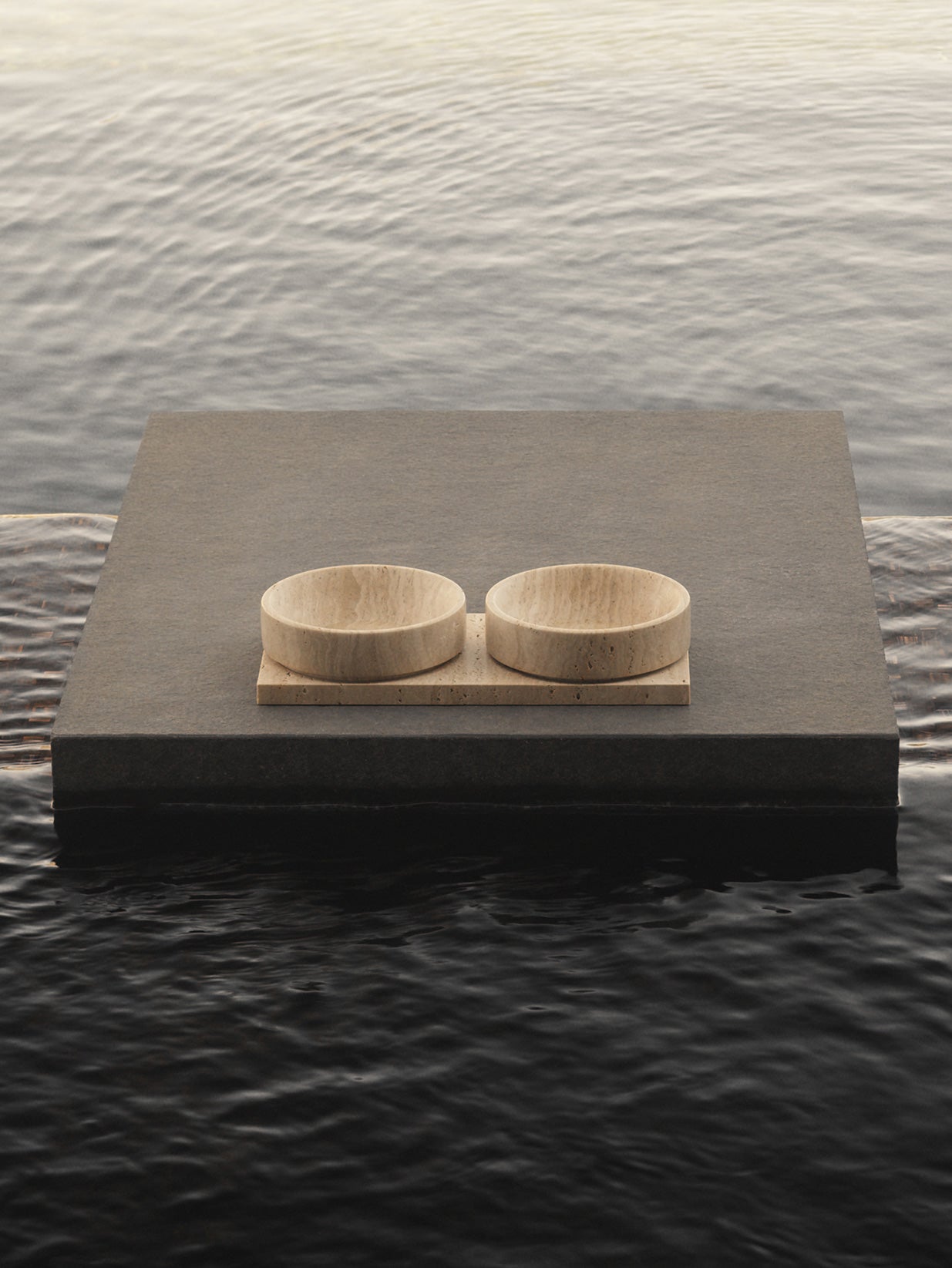 Mila travertine pet bowls on stone platform
by Studio Meu