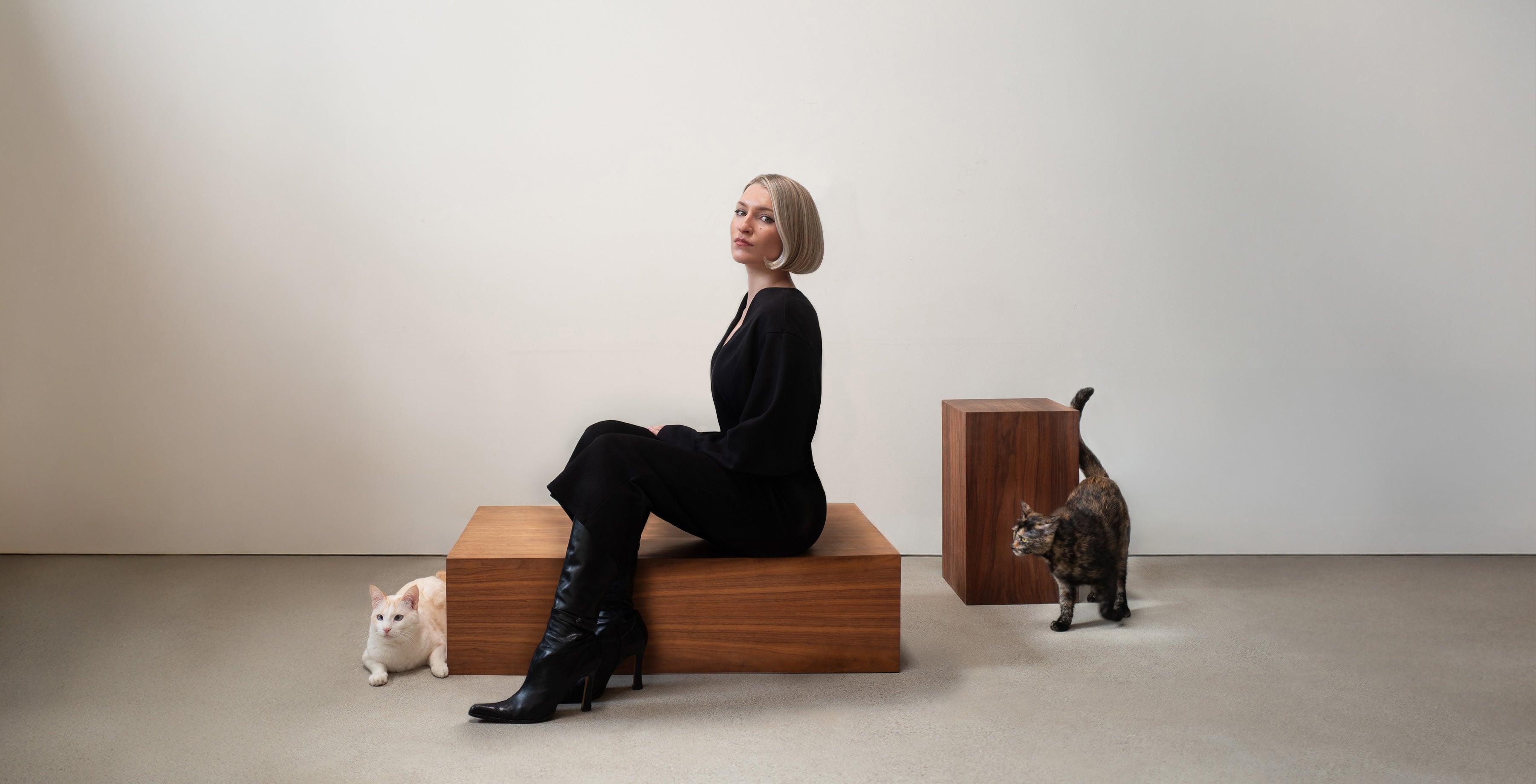 Studio Meu founder Jennifer Campbell seated with cats in design portrait